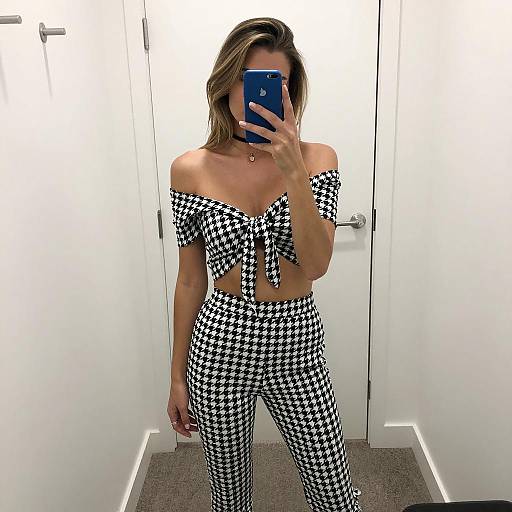 Woman in Black and White Houndstooth Outfit Taking Mirror Selfie