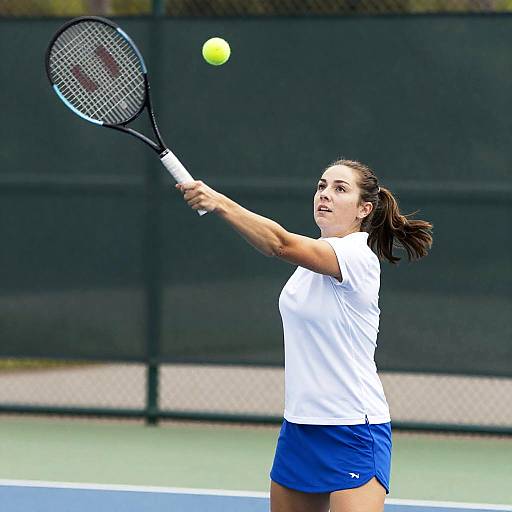 Female Tennis Player Mid-Serve