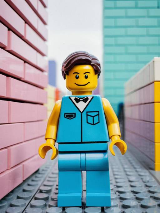 Lego Man in Blue Vest Amid Pastel Lego Walls
