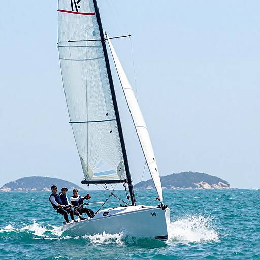 Photograph of a white sailboat with three sailors in black and white attire, slicing through vibrant blue ocean waves, with distant green hills and clear sky