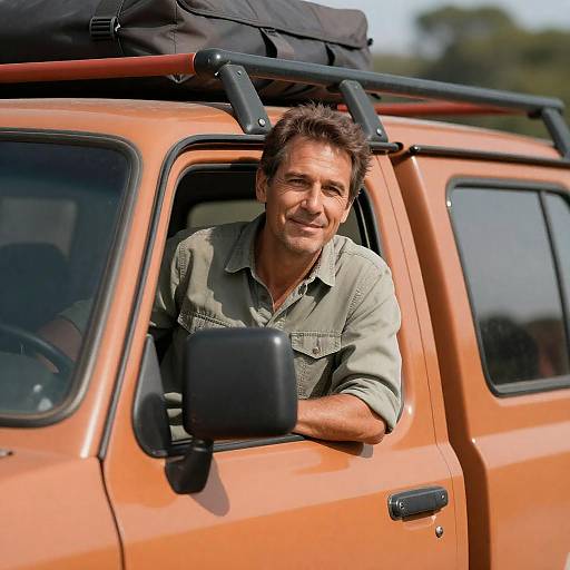 Man Leaning Out of Orange Truck
