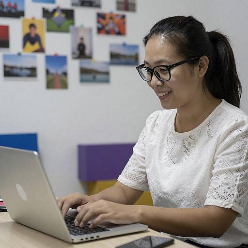 Smiling Asian Woman at Laptop Desk