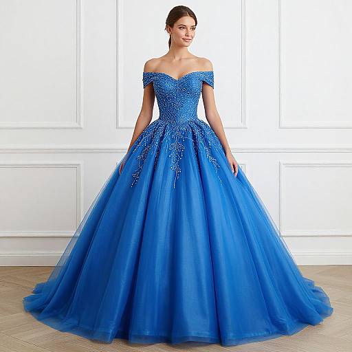 Photograph of a smiling woman in an off-the-shoulder, vibrant blue, full-skirted ball gown with intricate beadwork, standing in