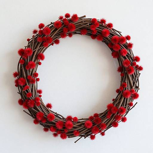 Photograph of a circular wreath made from dark brown twigs, adorned with evenly spaced vibrant red, fluffy pom-poms.
