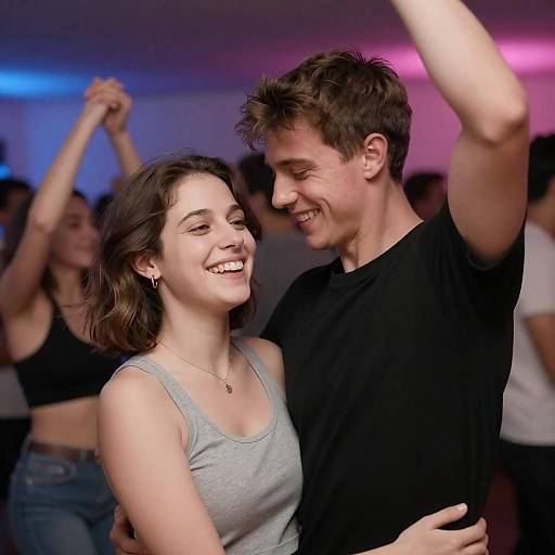 Joyful Couple Dancing in Colorful Lights