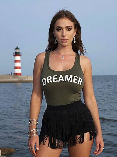 Photograph of a brunette woman with long hair, wearing a green tank top with 