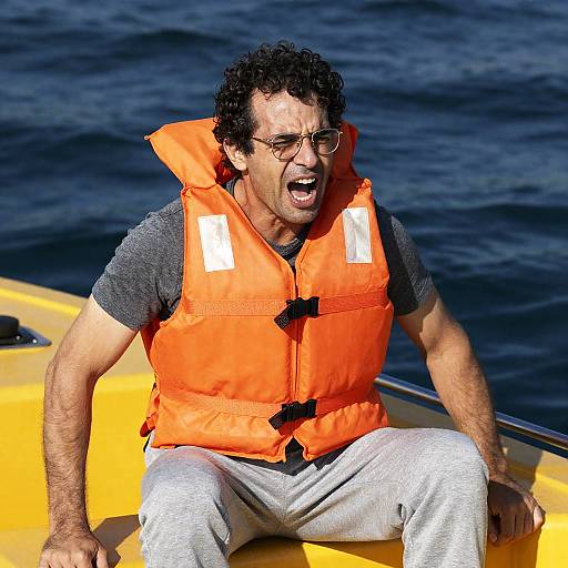 Man Shouting in Life Jacket on Yellow Boat