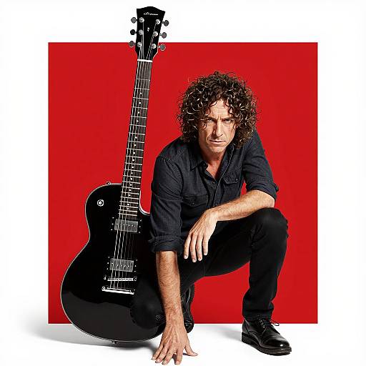 Man with Large Black Guitar on Red Background
