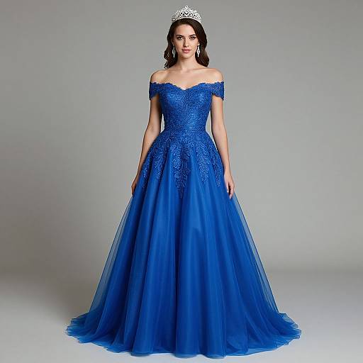 Photograph of a fair-skinned woman with dark hair, wearing an off-shoulder, blue, lace and tulle ball gown with a silver