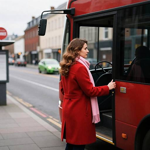 Stylish Woman Boarding a Red Bus