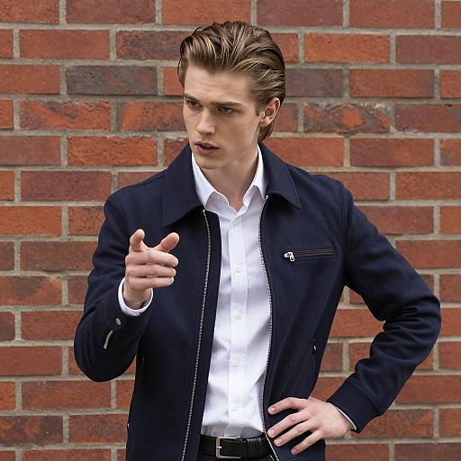 Intense Young Man Against Brick Wall