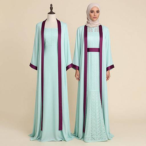 Photograph of a woman in a light blue, lace-trimmed, long-sleeve robe with purple trim, white lace dress, and white