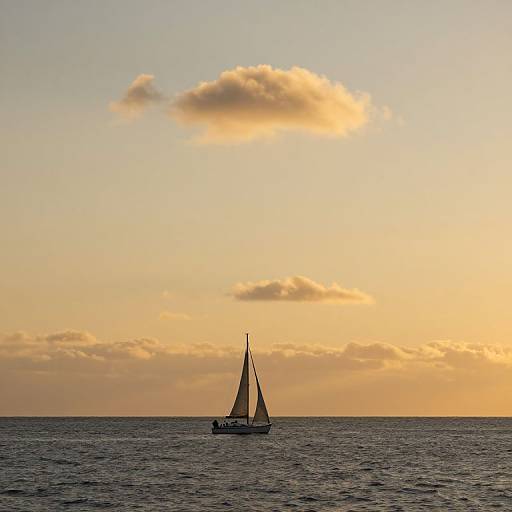 Photograph of a solitary sailboat with dark sails on a calm ocean at sunset, under a golden sky with a single fluffy cloud.