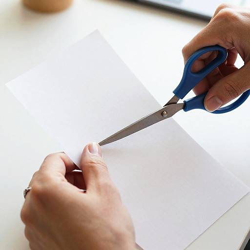 Hands Cutting Paper Close-Up