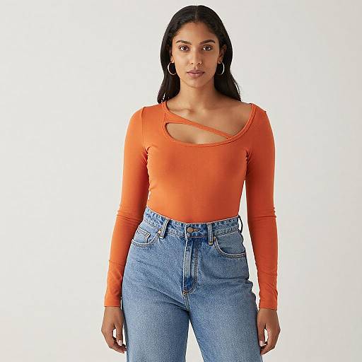 Confident Woman in Orange Top and Jeans