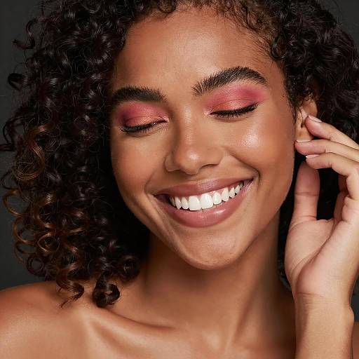 Smiling Woman with Curly Hair and Colorful Eyeshadow