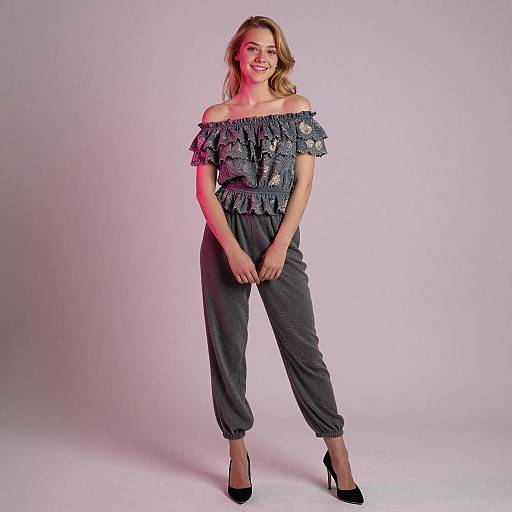 Smiling Blonde Woman in Ruffled Gray Outfit