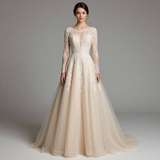 Photograph of a woman in a full-length, white lace wedding gown with long sleeves and a fitted bodice, standing against a plain gray background.