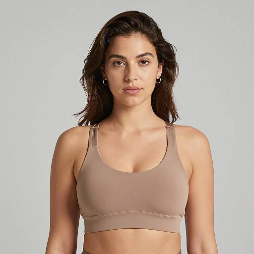 Woman in Tan Sports Bra Against Gray Background