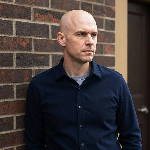 Serious Bald Man Against Brick Wall