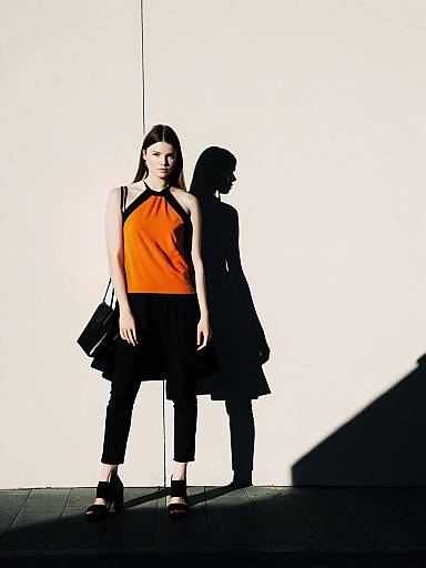 Woman in Orange Halter Top and Black Pants