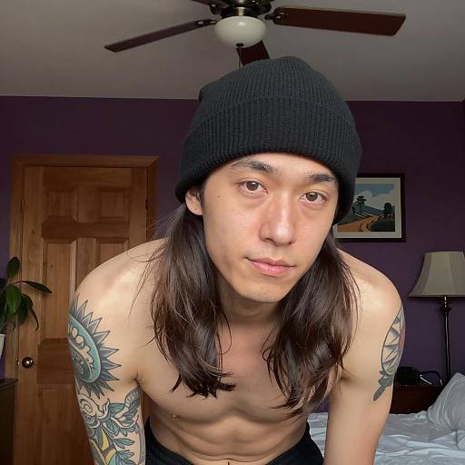 Tattoed Man in a Stylish Indoor Setting