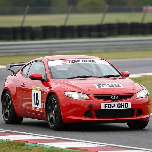Photograph of a red Ford Focus rally car, number 10, with 