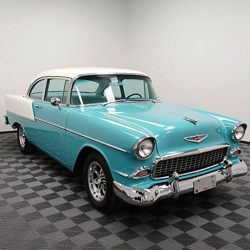 Photograph of a vintage, two-tone turquoise and white 1950s Chevrolet sedan with chrome accents, parked on a black and gray checkered floor