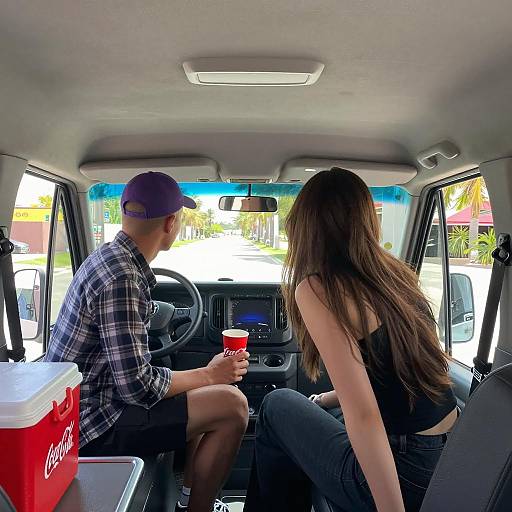 Two People Inside Van with Coca-Cola Drink