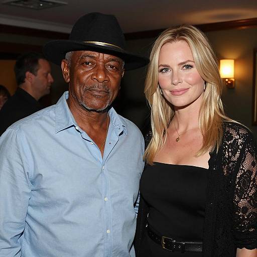 Middle-aged man and blonde woman in dimly lit room