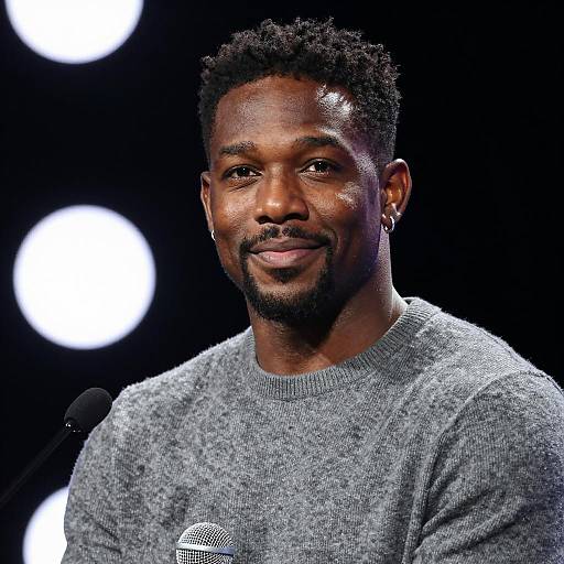 Smiling Black Man Speaking at Microphone