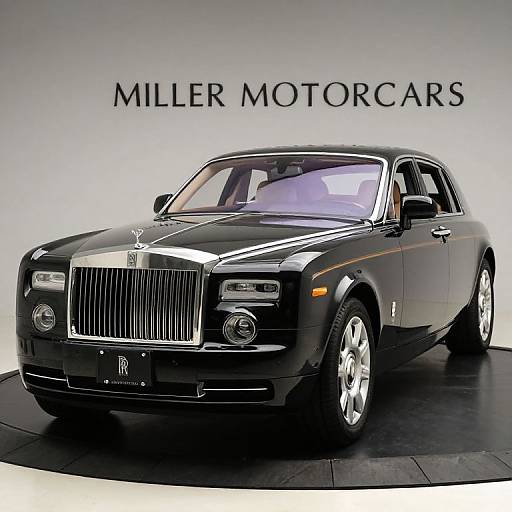 Photograph of a sleek, black Rolls-Royce Phantom VII Mulsanne, displayed on a black platform with 