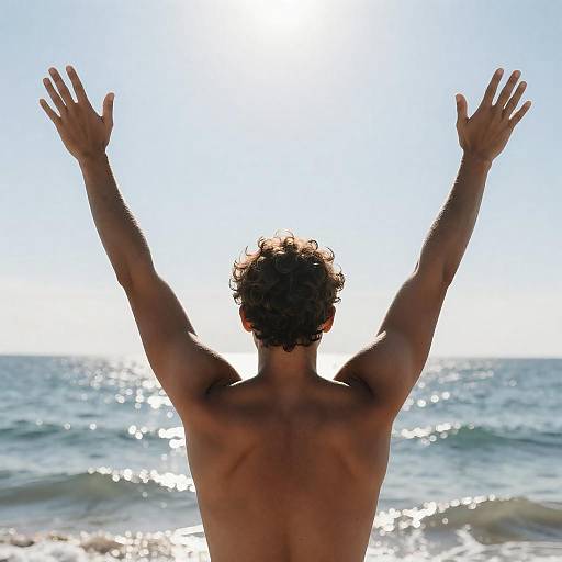 Silhouetted Man Embracing Sunlit Ocean