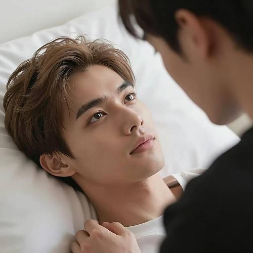 Intense Gaze Between Two Men on White Bed