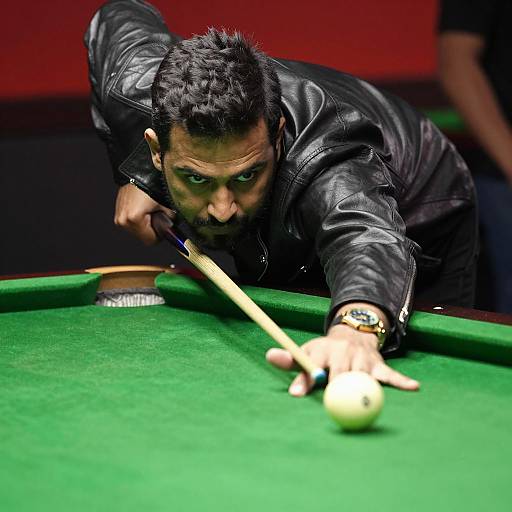 Man aiming cue in indoor pool game