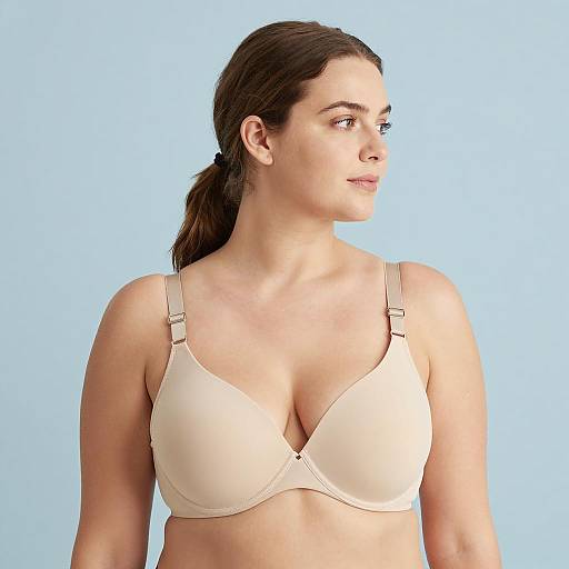 Woman Wearing Beige Bra on Light Blue Background