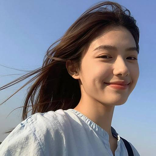 Young Woman Smiling Under Blue Sky