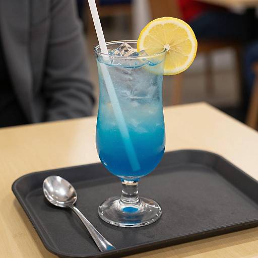 Refreshing Blue Cocktail on Yellow Table