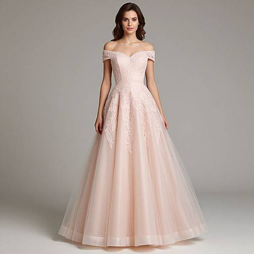 Photograph of a young woman with wavy brown hair wearing an off-the-shoulder, white lace and tulle ball gown, standing against a