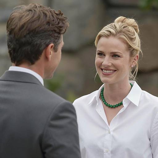 Smiling Woman in White Shirt Talking to Man in Suit