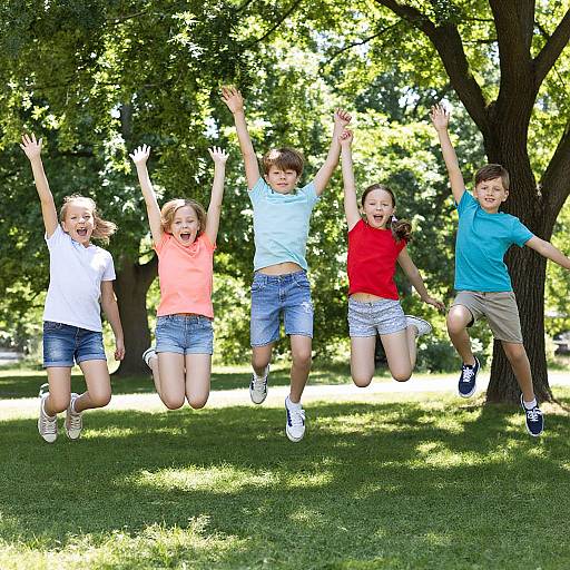Photograph of five children jumping joyfully in a sunny park, wearing casual summer clothes, arms raised, surrounded by lush green trees.