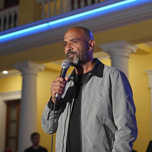 Middle-aged Man Speaking with Microphone Outdoors at Night