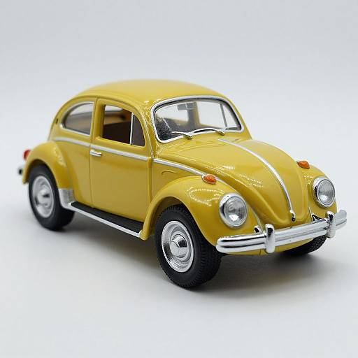 Photograph of a detailed, bright yellow vintage Volkswagen Beetle model car with chrome accents, white-walled tires, and a shiny finish, set against a