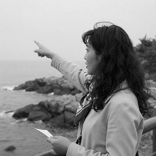 Woman Pointing on Rocky Coastline