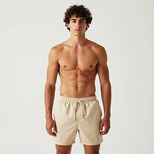 Confident Muscular Man in Beige Shorts