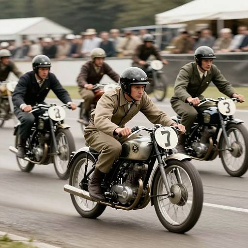 Photograph of three vintage motorcycle riders in military uniforms and black helmets, racing on a road with blurred spectators in the background.