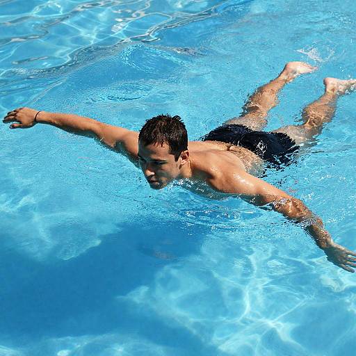 Focused Swimmer in Clear Blue Pool