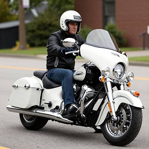 Photograph of a man in black jacket and jeans, white helmet, riding a white Harley-Davidson motorcycle on a street.