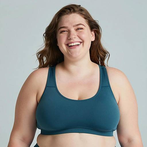 Smiling Plus-Size Woman in Teal Sports Bra