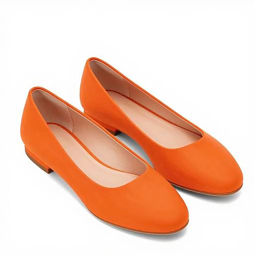 Photograph of bright orange, glossy, flat-heeled women's pumps with rounded toes, positioned side by side on a white background.